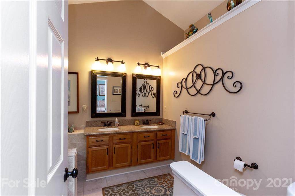 7401 Reedy Creek Road, Unit 24 Charlotte, NC 28215 - Photo 19 of 31 a bathroom with a sink and a mirror