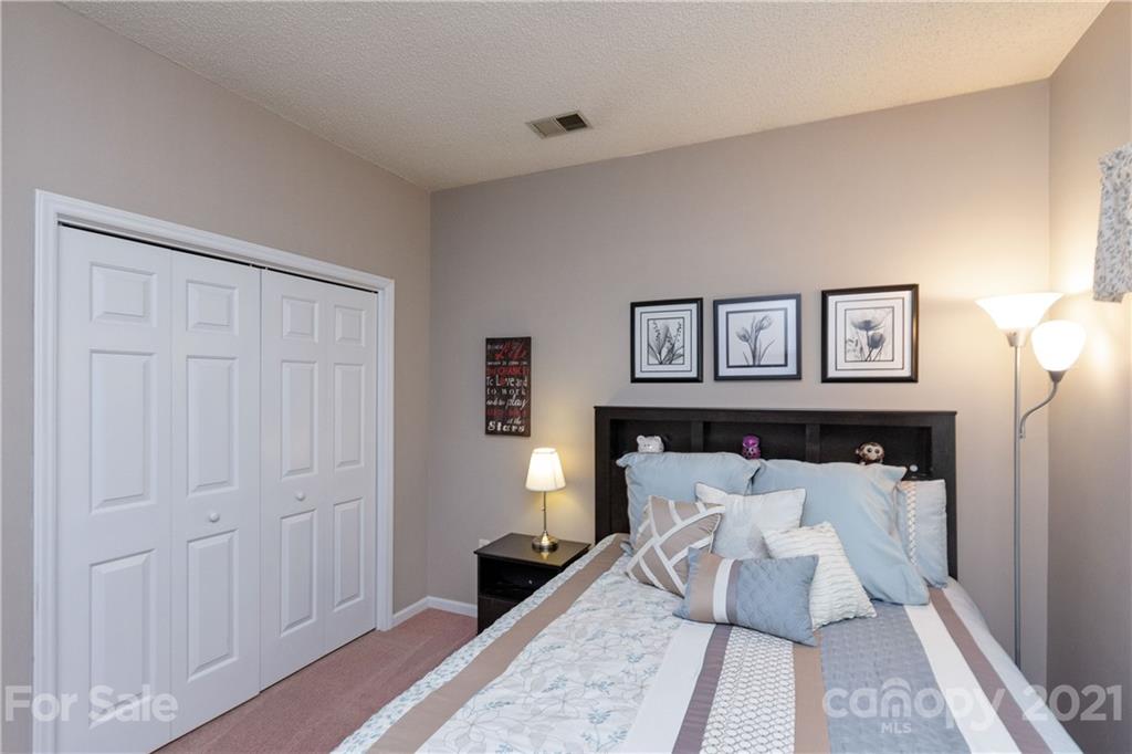 7401 Reedy Creek Road, Unit 24 Charlotte, NC 28215 - Photo 21 of 31 a bed room with a bed and mirror