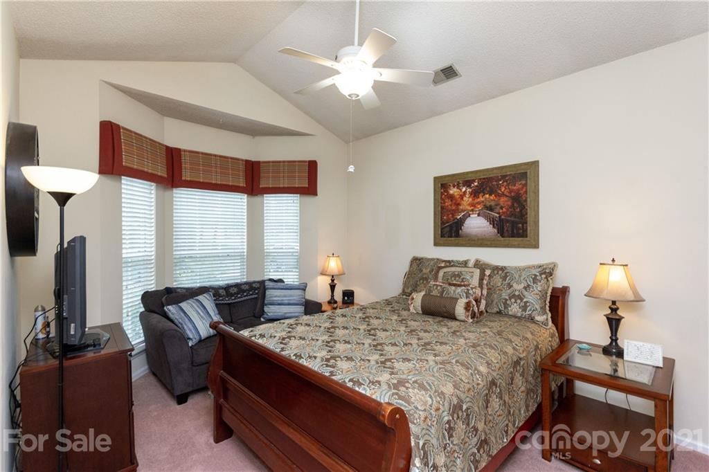 7401 Reedy Creek Road, Unit 24 Charlotte, NC 28215 - Photo 22 of 31 a bedroom with a bed and wooden floor