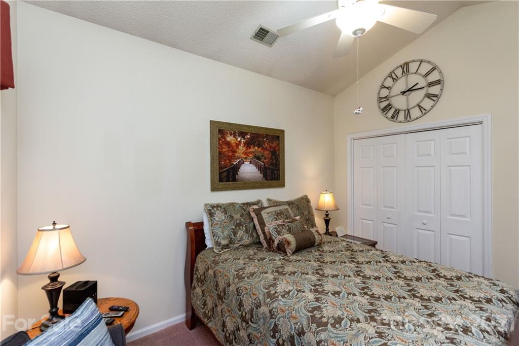7401 Reedy Creek Road, Unit 24 Charlotte, NC 28215 - Photo 23 of 31 a bedroom with a bed and wooden floor