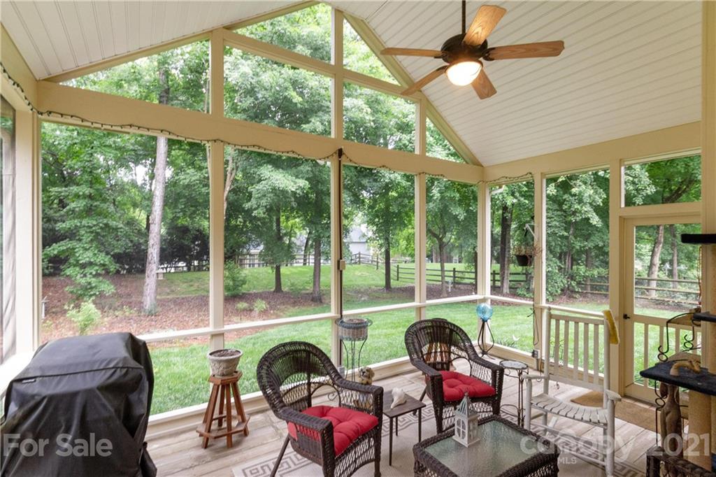 7401 Reedy Creek Road, Unit 24 Charlotte, NC 28215 - Photo 24 of 31 a living room with furniture and floor to ceiling windows