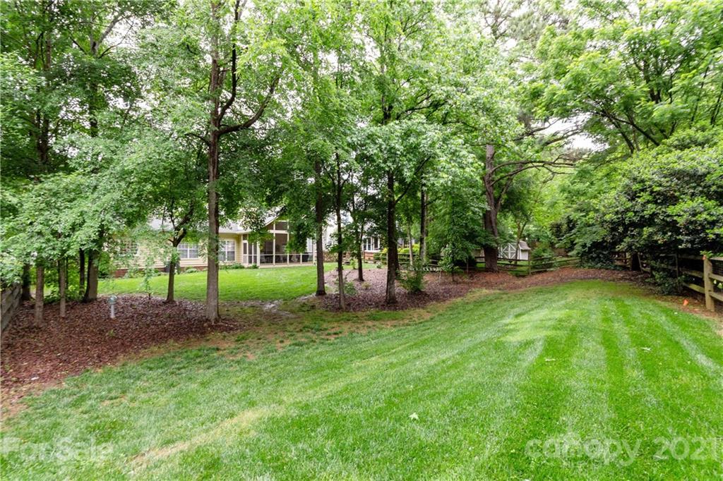 7401 Reedy Creek Road, Unit 24 Charlotte, NC 28215 - Photo 25 of 31 a green field with lots of trees