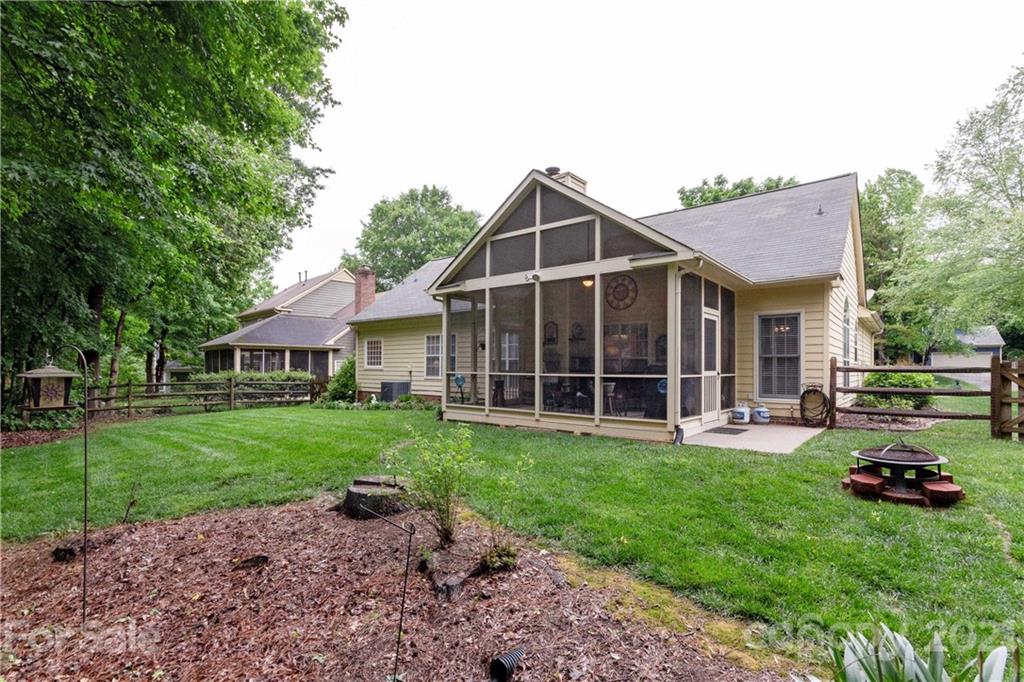 7401 Reedy Creek Road, Unit 24 Charlotte, NC 28215 - Photo 29 of 31 a view of a house with a yard and sitting area