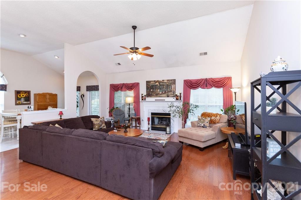 7401 Reedy Creek Road, Unit 24 Charlotte, NC 28215 - Photo 4 of 31 a living room with furniture fireplace and a chandelier