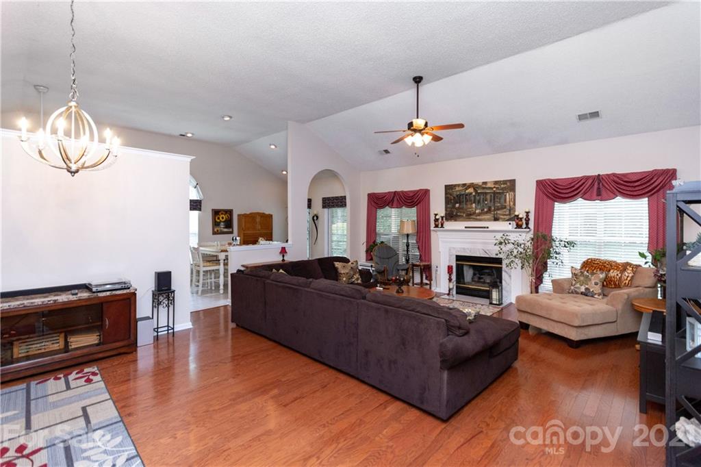 7401 Reedy Creek Road, Unit 24 Charlotte, NC 28215 - Photo 5 of 31 a living room with furniture fireplace and a chandelier