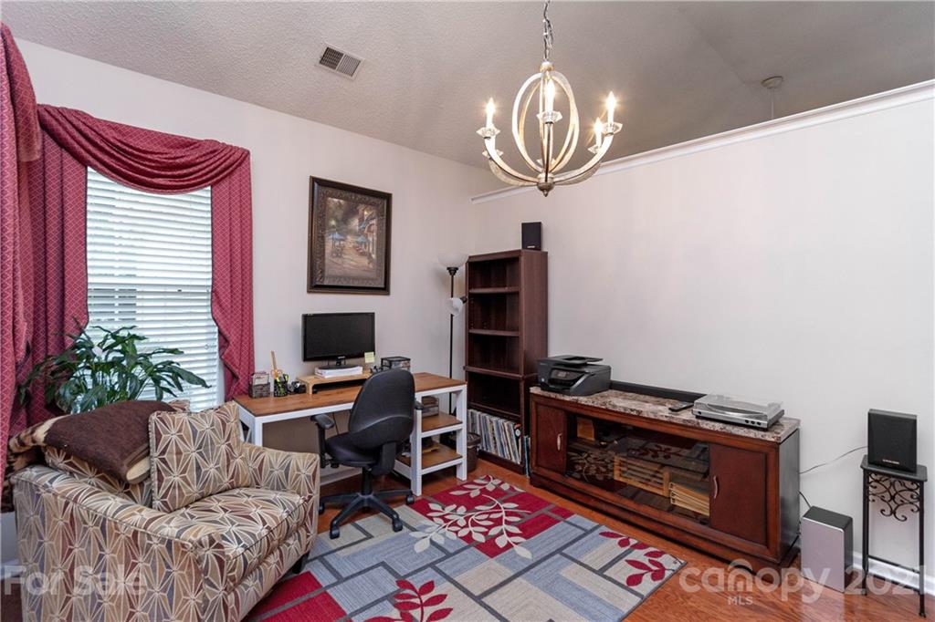 7401 Reedy Creek Road, Unit 24 Charlotte, NC 28215 - Photo 6 of 31 a living room with furniture and a fireplace