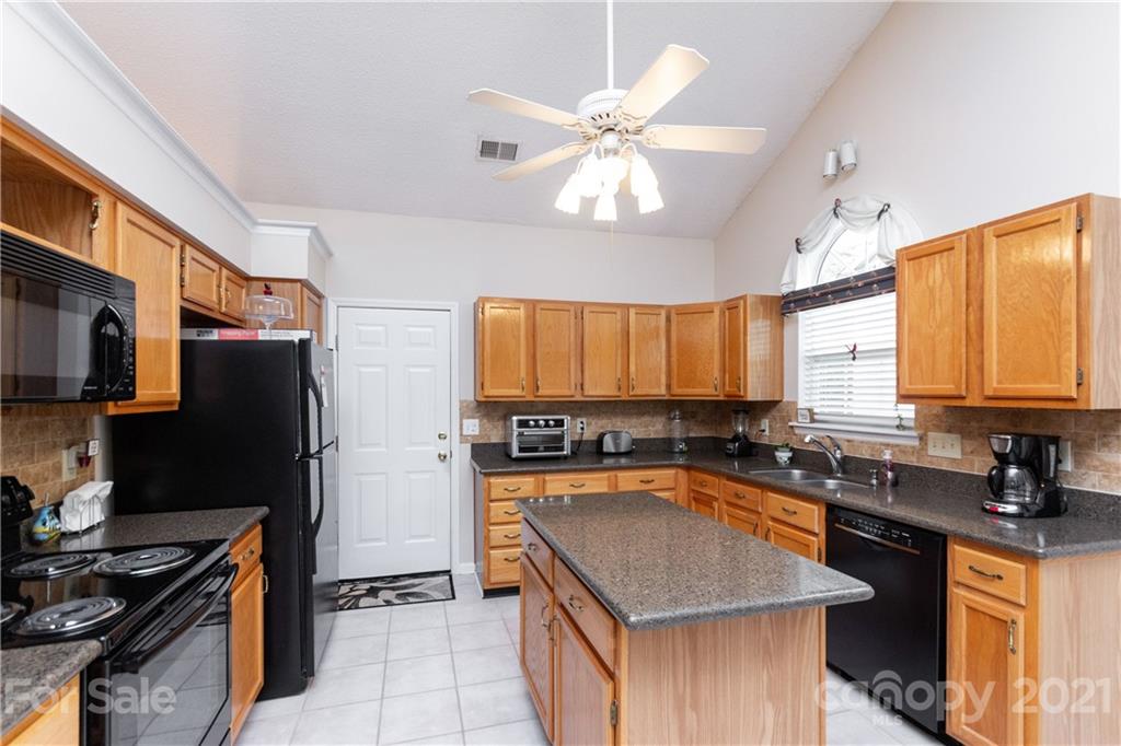 7401 Reedy Creek Road, Unit 24 Charlotte, NC 28215 - Photo 10 of 31 a kitchen with stainless steel appliances granite countertop a sink stove and refrigerator