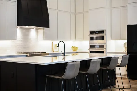 a kitchen with a table chairs and a window