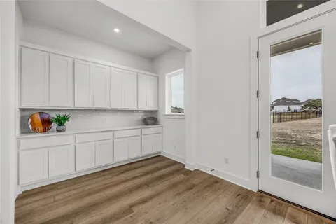 a kitchen with granite countertop white cabinets and white appliances