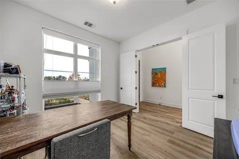 a view of a workspace with furniture and wooden floor