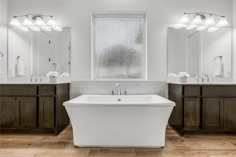 a white sink sitting under a chandelier