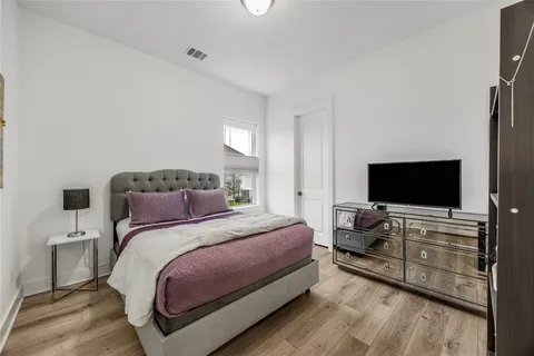 a bedroom with a bed and a flat screen tv