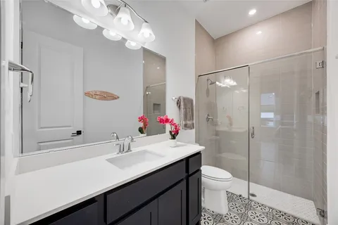 a bathroom with a sink a toilet and shower