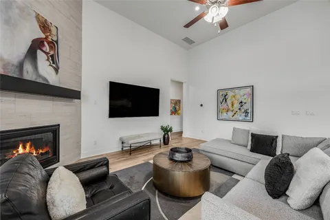 a living room with furniture a flat screen tv and a fireplace