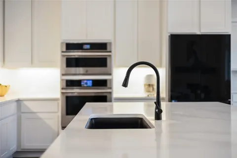 a kitchen with a sink and a stove