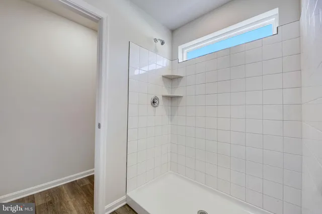 a brick house that has a small yard and a large window