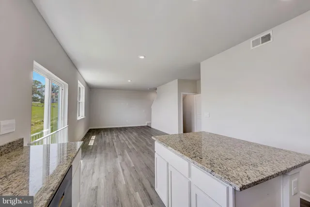 a view of a kitchen cabinets and wooden floor