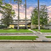 a view of a big house with a big yard and plants