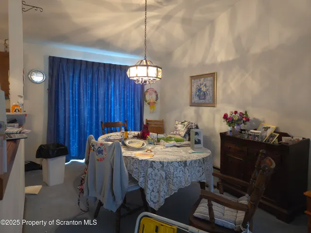 a view of a dining room with furniture and chandelier
