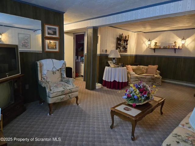 a living room with furniture and flowers