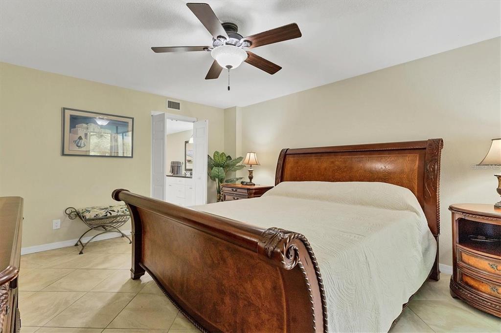 8776 Midnight Pass Road, Unit C307 Sarasota, FL 34242 - Photo 13 of 45 a bedroom with a bed and chair