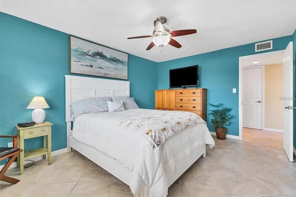 a bedroom with a bed and a chandelier