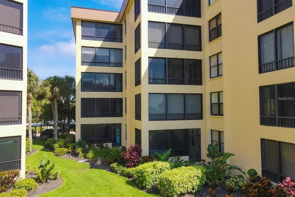 8776 Midnight Pass Road, Unit C307 Sarasota, FL 34242 - Photo 23 of 45 a view of a building with a yard