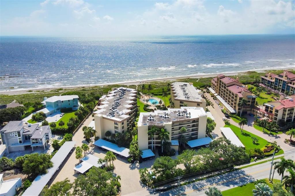 8776 Midnight Pass Road, Unit C307 Sarasota, FL 34242 - Photo 24 of 45 a view of a city with lawn chairs