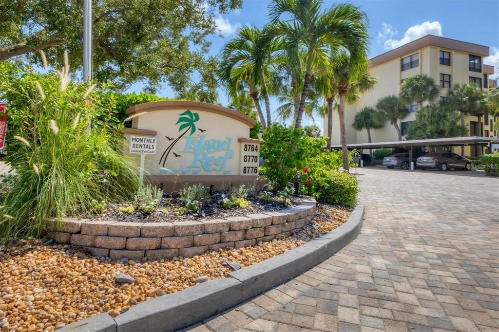 8776 Midnight Pass Road, Unit C307 Sarasota, FL 34242 - Photo 27 of 45 a view of a yard with plants and palm trees