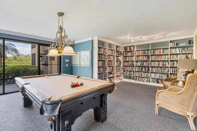 a room with pool table and windows