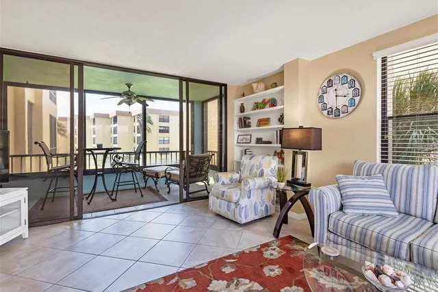 a living room with furniture and a floor to ceiling window