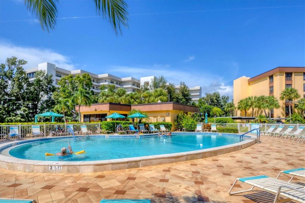 8776 Midnight Pass Road, Unit C307 Sarasota, FL 34242 - Photo 31 of 45 a view of a swimming pool with a patio