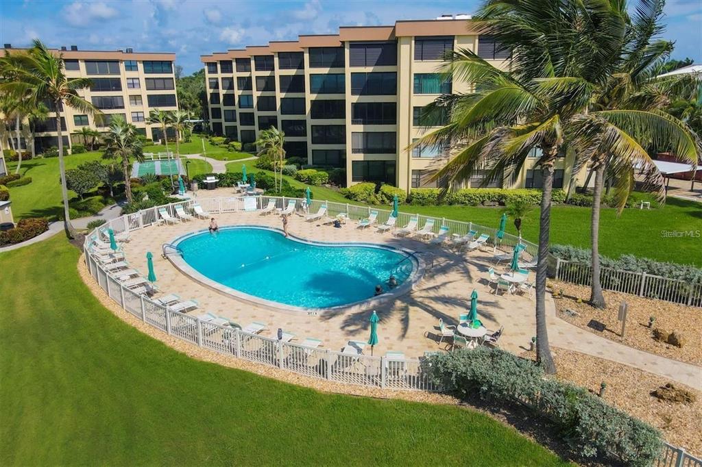 8776 Midnight Pass Road, Unit C307 Sarasota, FL 34242 - Photo 37 of 45 a view of a house with backyard and sitting area