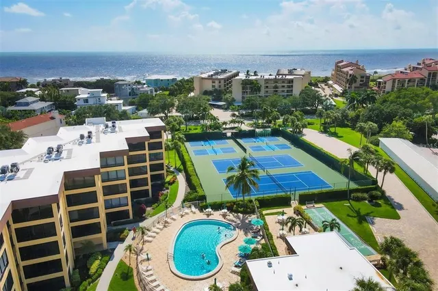an aerial view of a house with a swimming pool patio and outdoor seating