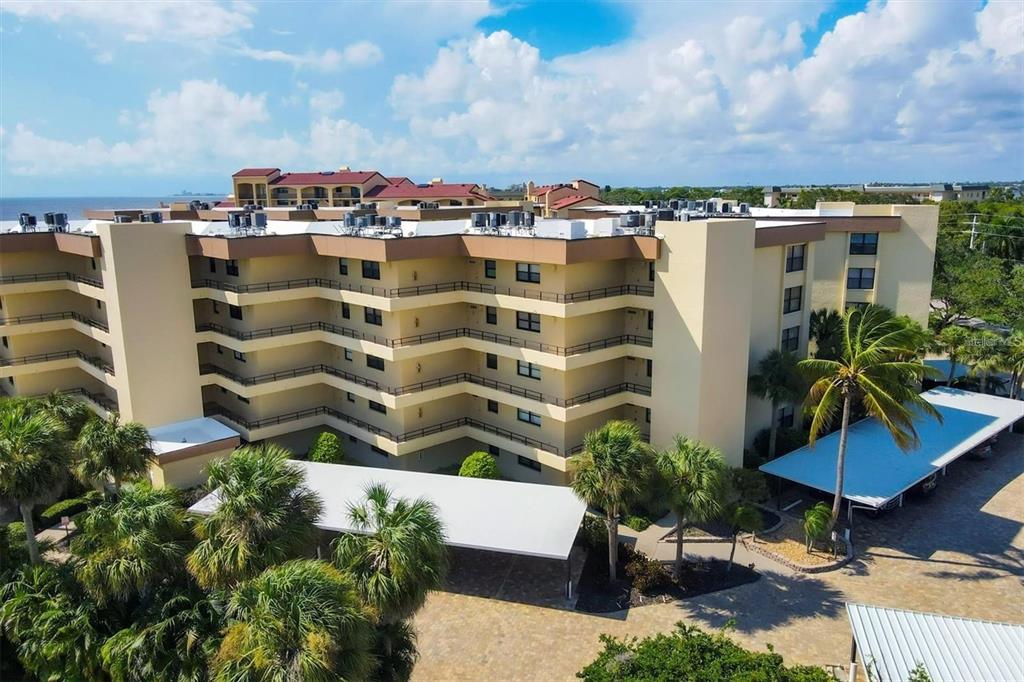 8776 Midnight Pass Road, Unit C307 Sarasota, FL 34242 - Photo 41 of 45 a view of a lake with a building in front of it