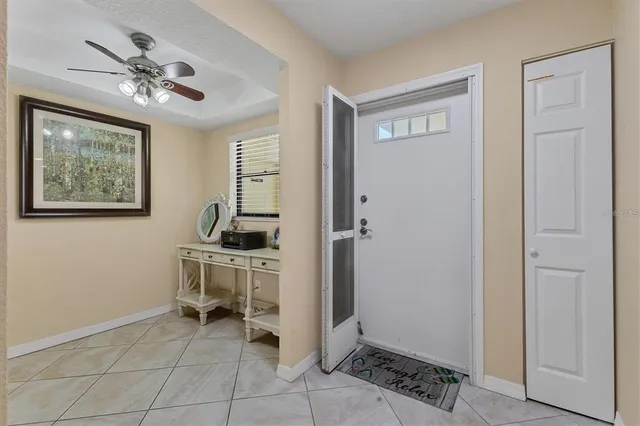 a view of a workspace with furniture and a chandelier fan