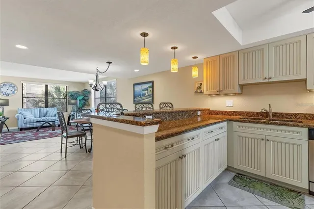a kitchen with granite countertop a sink cabinets and window