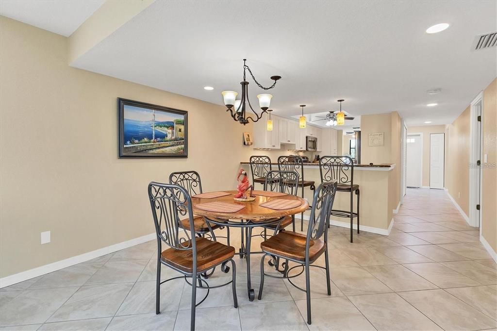 8776 Midnight Pass Road, Unit C307 Sarasota, FL 34242 - Photo 9 of 45 a view of a dining room with furniture