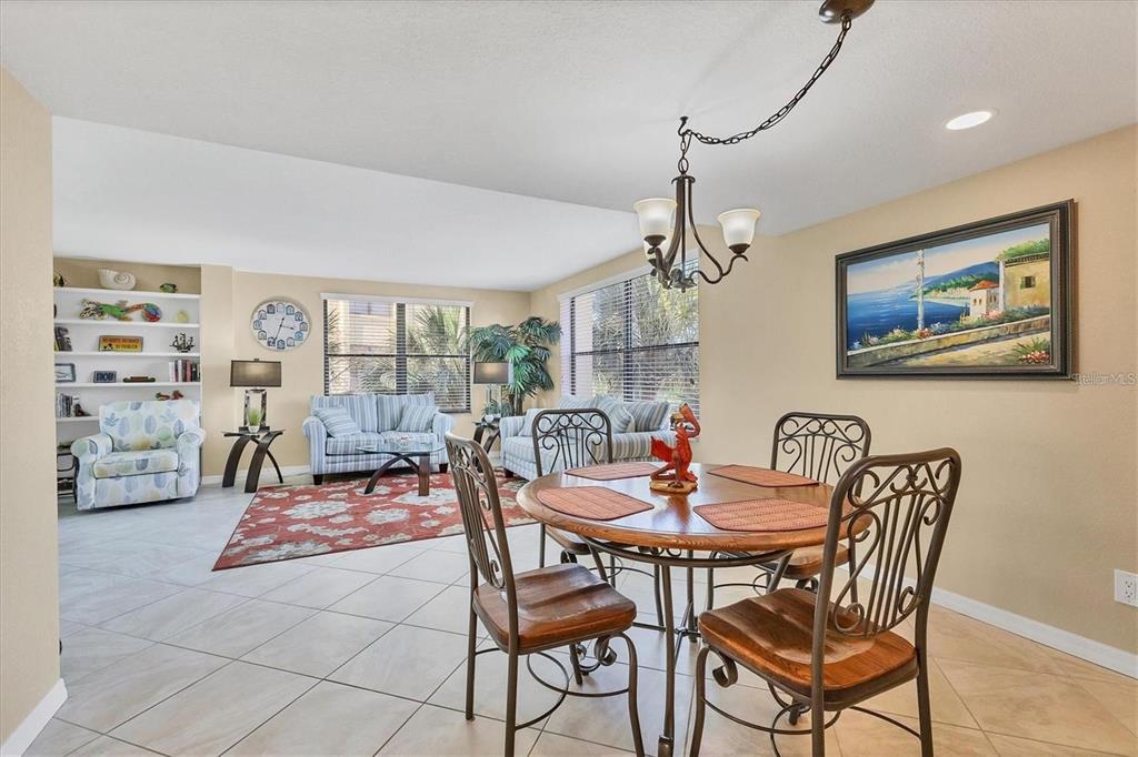 8776 Midnight Pass Road, Unit C307 Sarasota, FL 34242 - Photo 10 of 45 a dining room with furniture and window