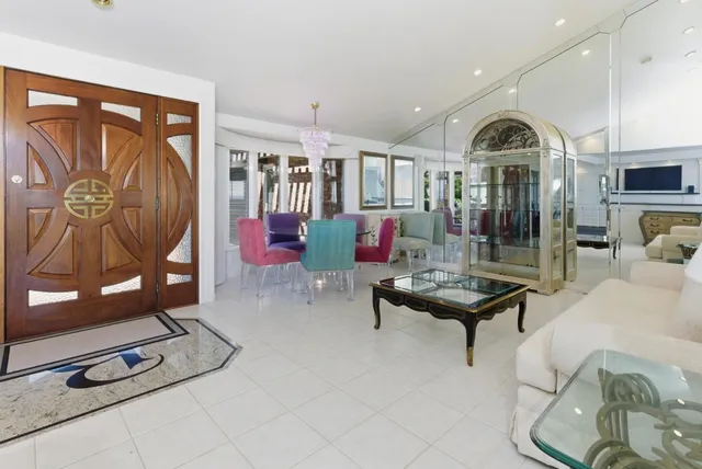 a living room with furniture and kitchen view