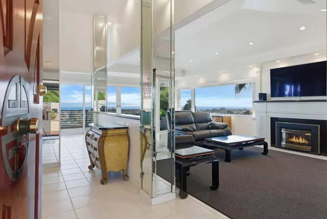 a living room with furniture and large windows