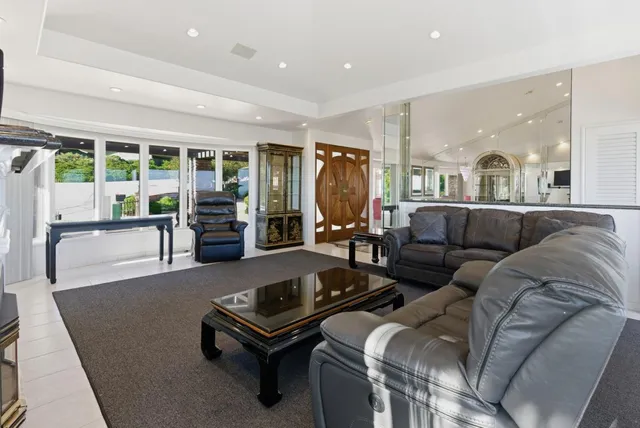 a large kitchen with granite countertop a large counter top appliances and cabinets