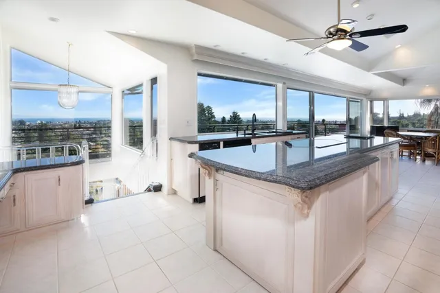 a kitchen with granite countertop a refrigerator and a sink