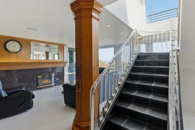 a view of a balcony with wooden chairs