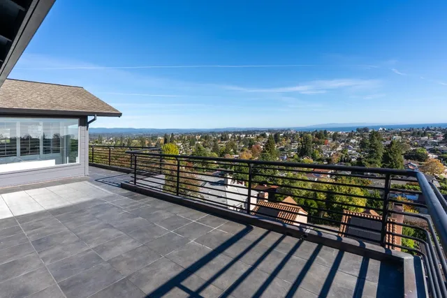 a view of a balcony with wooden floor and city view