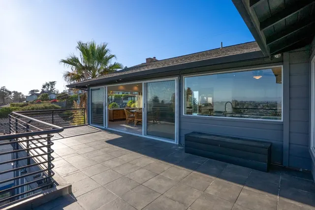 a view of a balcony with wooden benches