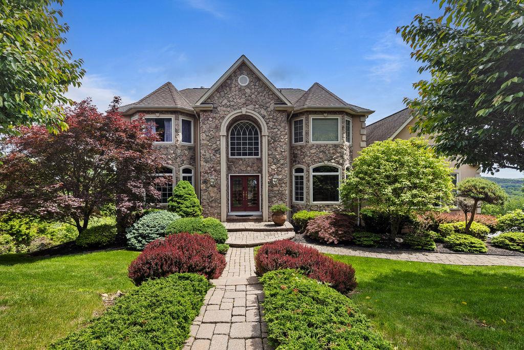 115 Overlook Road Pomona, NY 10970 - Photo 1 of 1 View of front of house with stone siding and a front lawn