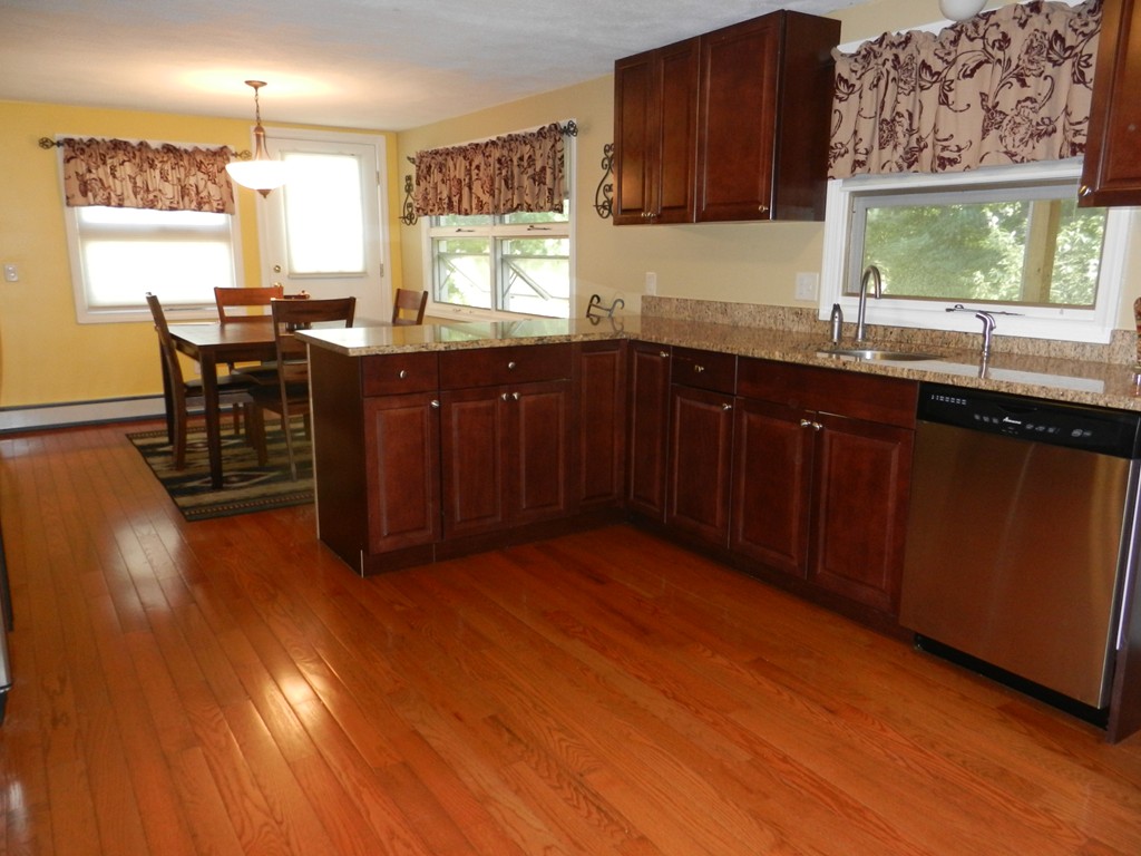 40 Indian Run Road Bellingham, MA 02019 - Photo 3 of 15 a kitchen with granite countertop wooden floors and sink