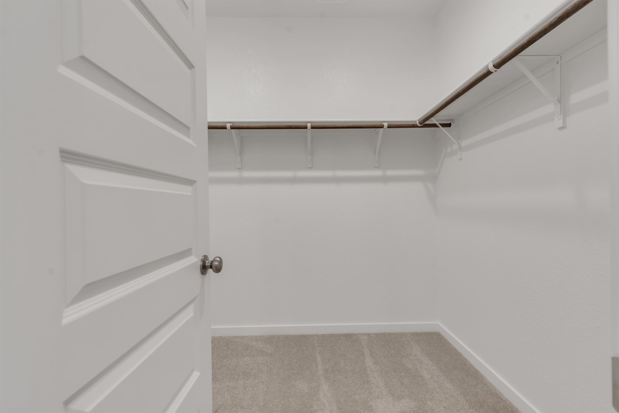 228 Bendecido Loop Elgin, TX 78621 - Photo 7 of 16 A well-organized closet space offers ample storage with built-in shelving and clothes rods.