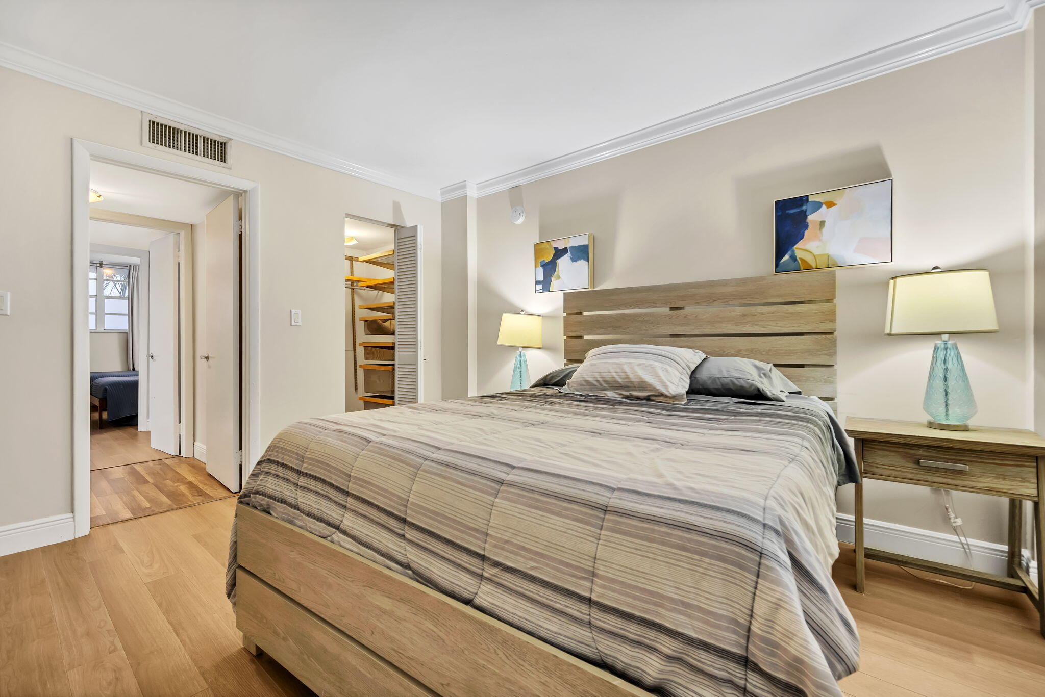 777 Northeast 62nd Street, Unit C512 Miami, FL 33138 - Photo 15 of 40 a bedroom with a bed and a night stand